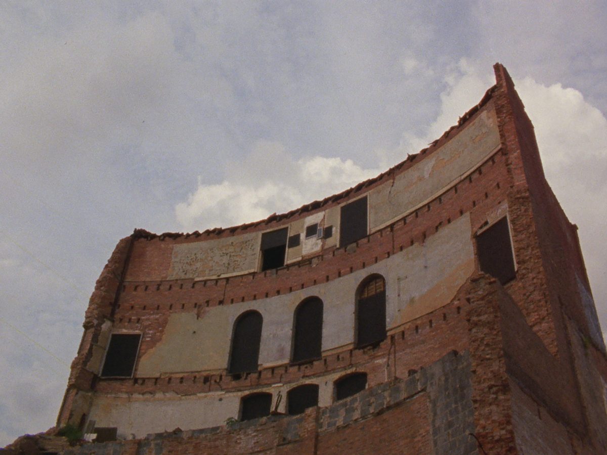 Still shot from Rorison's film BALTIMORE of an abandoned building against an overcast sky